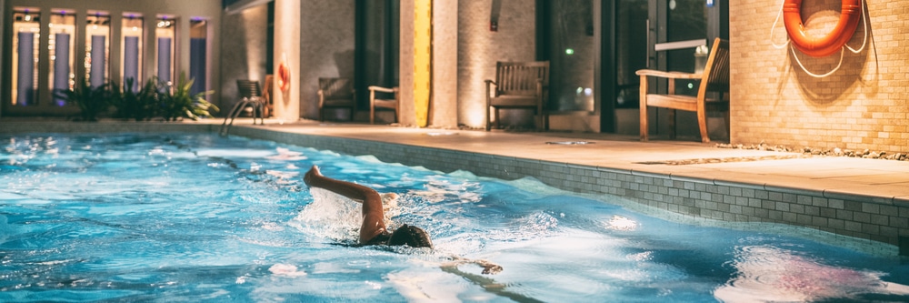 a photo of an individual swimming in the condo pool.