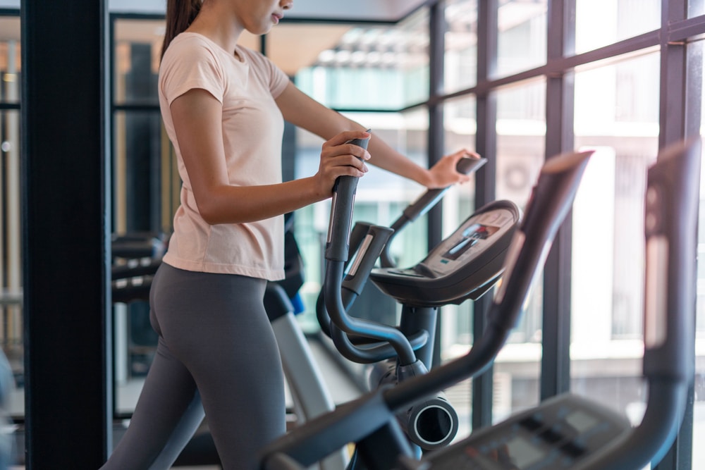 a photo of a person working out using a gym stepper.